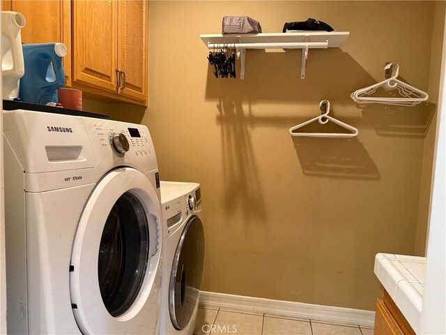23618 Canyon Lake Dr N, Canyon Lake, CA 92587 - laundry area featuring cabinet space, separate washer and dryer, light tile patterned floors, and baseboards
