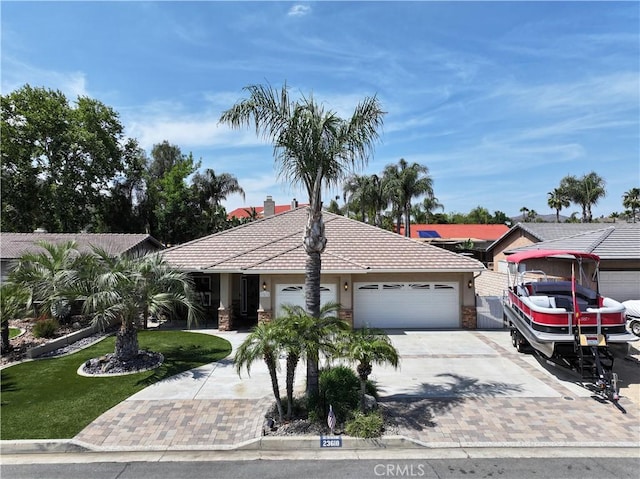 23618 Canyon Lake Dr N, Canyon Lake, CA 92587 - single story home with driveway, a garage, a front yard, stucco siding, and a tiled roof