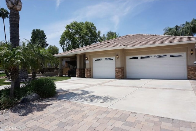 23618 Canyon Lake Dr N, Canyon Lake, CA 92587 - view of front of home with concrete driveway, an attached garage, stucco siding, a tiled roof, and stone siding