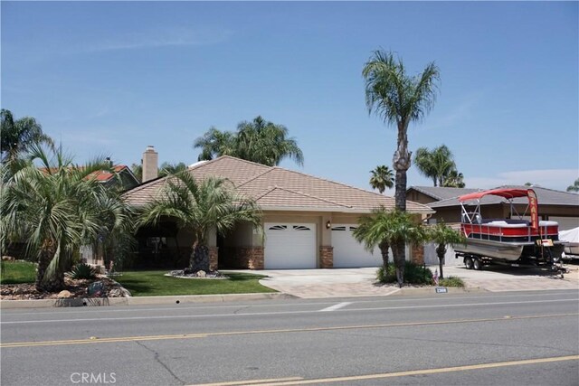 23618 Canyon Lake Dr N, Canyon Lake, CA 92587 - view of front of house featuring an attached garage, driveway, a chimney, and a tiled roof