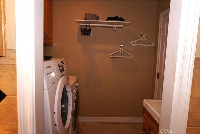 23618 Canyon Lake Dr N, Canyon Lake, CA 92587 - washroom with washer and clothes dryer, light tile patterned flooring, cabinet space, and baseboards