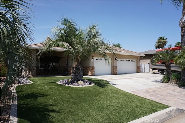 23618 Canyon Lake Dr N, Canyon Lake, CA 92587 - view of front of property featuring concrete driveway, a front yard, an attached garage, and stone siding