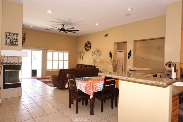 23618 Canyon Lake Dr N, Canyon Lake, CA 92587 - dining room featuring a tile fireplace, light tile patterned floors, a ceiling fan, and recessed lighting
