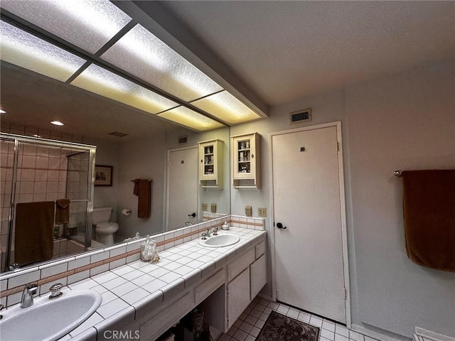 19628 Pine Valley Ave, Porter Ranch, CA 91326 - bathroom featuring a shower stall, tile patterned flooring, toilet, and double vanity
