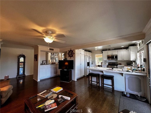 19628 Pine Valley Ave, Porter Ranch, CA 91326 - living room with crown molding, dark wood finished floors, a ceiling fan, and a textured ceiling