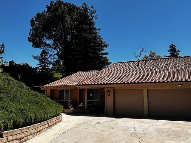 19628 Pine Valley Ave, Porter Ranch, CA 91326 - view of front of house with concrete driveway, a tiled roof, and an attached garage