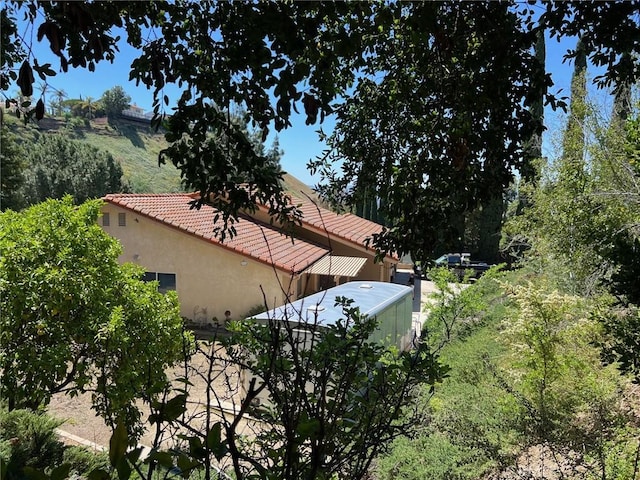19628 Pine Valley Ave, Porter Ranch, CA 91326 - view of side of home featuring stucco siding and a tiled roof