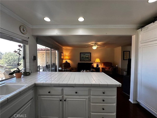 19628 Pine Valley Ave, Porter Ranch, CA 91326 - kitchen featuring a peninsula, tile counters, open floor plan, ceiling fan, and crown molding