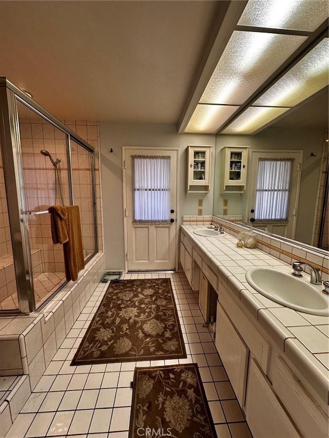 19628 Pine Valley Ave, Porter Ranch, CA 91326 - bathroom featuring tile patterned floors, a shower stall, and double vanity
