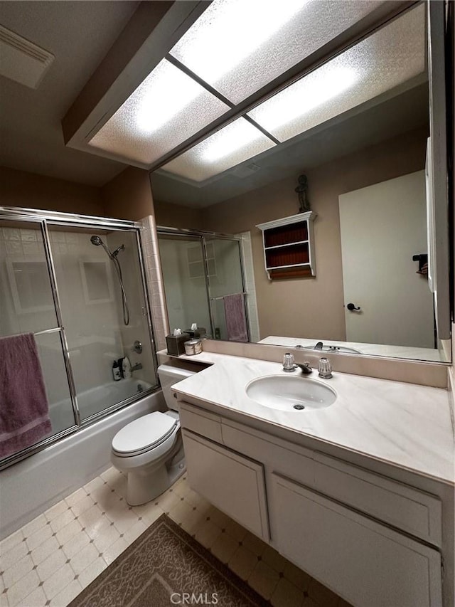 19628 Pine Valley Ave, Porter Ranch, CA 91326 - full bathroom featuring bath / shower combo with glass door, toilet, vanity, and tile patterned floors