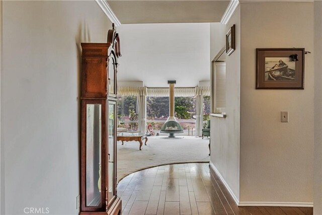 19628 Pine Valley Ave, Porter Ranch, CA 91326 - hallway with wood finished floors, baseboards, and crown molding