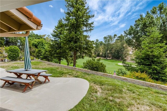 19628 Pine Valley Ave, Porter Ranch, CA 91326 - view of green lawn with a patio and view of wooded area