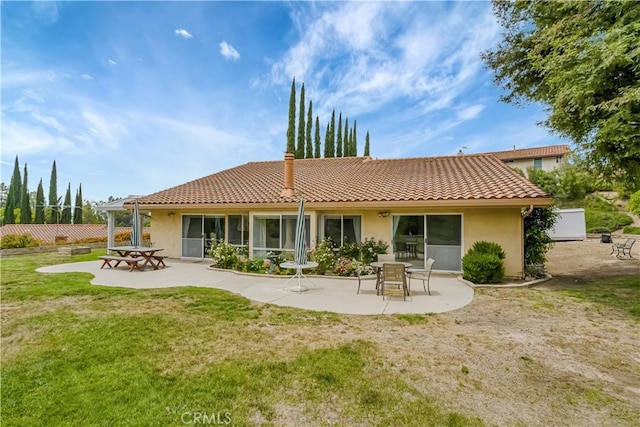 19628 Pine Valley Ave, Porter Ranch, CA 91326 - back of house featuring a tile roof, a patio, stucco siding, and a lawn
