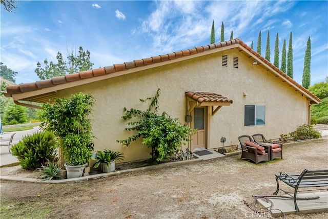 19628 Pine Valley Ave, Porter Ranch, CA 91326 - rear view of property with a tiled roof and stucco siding