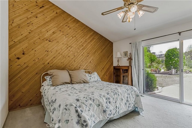19628 Pine Valley Ave, Porter Ranch, CA 91326 - carpeted bedroom featuring wooden walls, access to exterior, a ceiling fan, and vaulted ceiling
