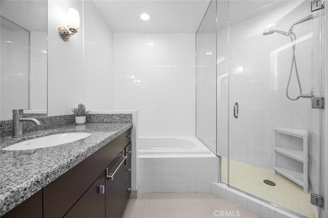 1100 Wilshire Blvd Unit 3005, Los Angeles, CA 90017 - full bath featuring tile patterned floors, a stall shower, a garden tub, and vanity