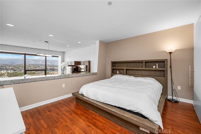 1100 Wilshire Blvd Unit 3005, Los Angeles, CA 90017 - bedroom featuring refrigerator, baseboards, wood finished floors, and recessed lighting