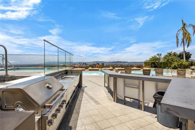 1100 Wilshire Blvd Unit 3005, Los Angeles, CA 90017 - view of patio / terrace with area for grilling, an outdoor pool, a mountain view, and exterior bar