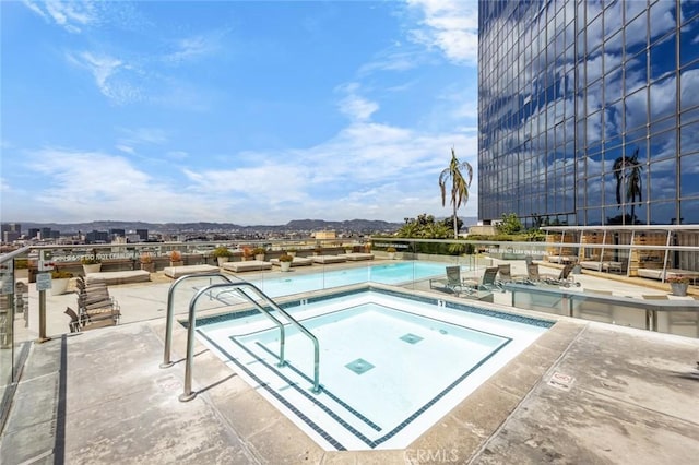 1100 Wilshire Blvd Unit 3005, Los Angeles, CA 90017 - community pool featuring a hot tub, a mountain view, and a patio area