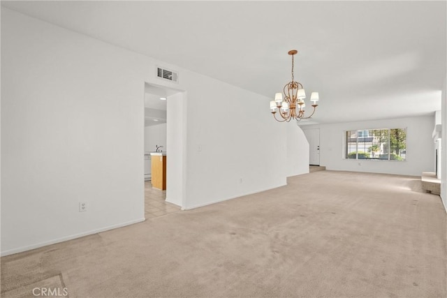 5564 Capri Ct, Palmdale, CA 93552 - unfurnished living room with a chandelier, light colored carpet, and baseboards