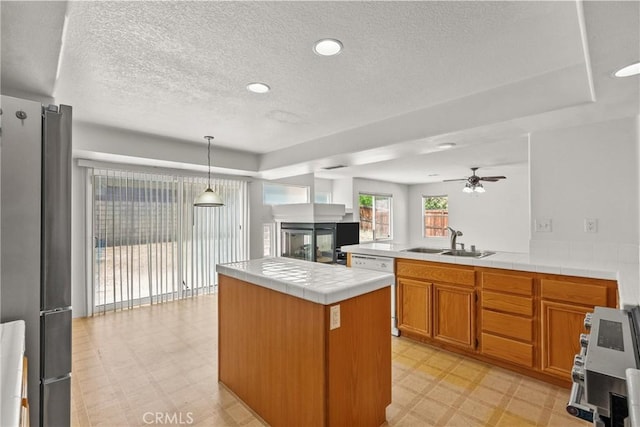 5564 Capri Ct, Palmdale, CA 93552 - kitchen featuring light flooring, a sink, appliances with stainless steel finishes, a textured ceiling, and a peninsula