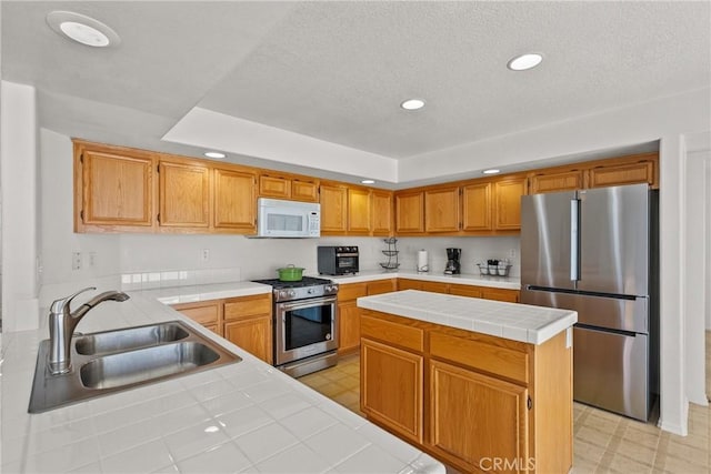 5564 Capri Ct, Palmdale, CA 93552 - kitchen featuring stainless steel appliances, a sink, tile counters, recessed lighting, and light flooring