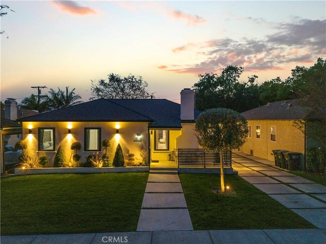 2048 W Kenneth Rd, Glendale, CA 91201 - view of front of house with a chimney, a yard, and stucco siding