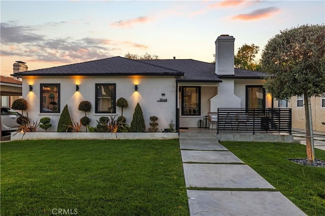 2048 W Kenneth Rd, Glendale, CA 91201 - view of front of home featuring a chimney, a front lawn, and stucco siding