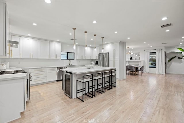2048 W Kenneth Rd, Glendale, CA 91201 - kitchen featuring stainless steel appliances, a sink, a breakfast bar area, a kitchen island, and wine cooler
