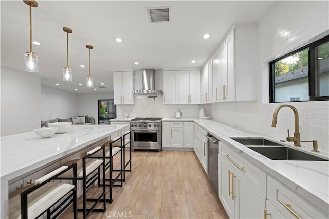 2048 W Kenneth Rd, Glendale, CA 91201 - kitchen with stainless steel appliances, wall chimney exhaust hood, a sink, recessed lighting, and white cabinetry