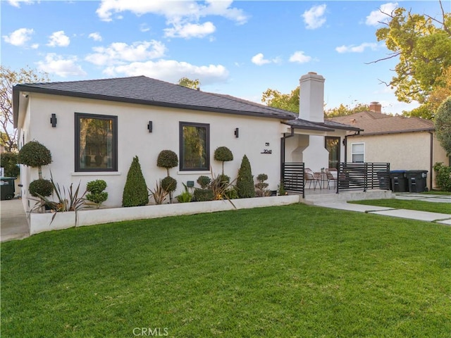 2048 W Kenneth Rd, Glendale, CA 91201 - view of front of house featuring a front yard, a chimney, and stucco siding