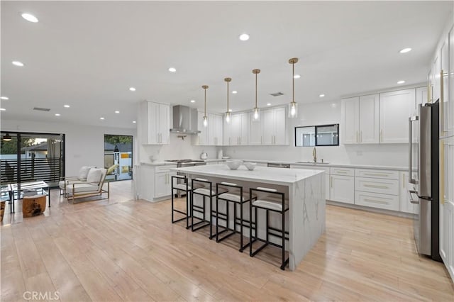 2048 W Kenneth Rd, Glendale, CA 91201 - kitchen featuring freestanding refrigerator, a sink, wall chimney exhaust hood, a center island, and a breakfast bar