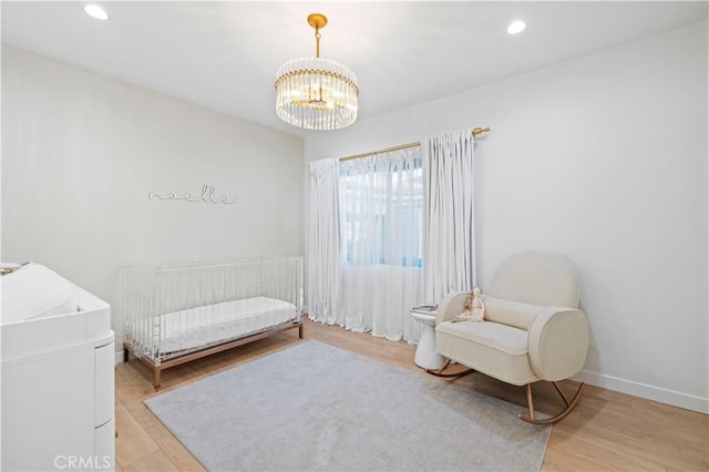 2048 W Kenneth Rd, Glendale, CA 91201 - bedroom with light wood finished floors, a chandelier, a crib, recessed lighting, and baseboards