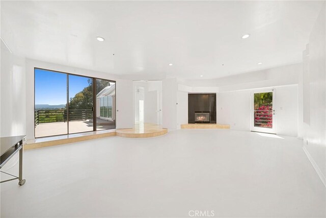 9314 Stevens Way, West Hills, CA 91304 - unfurnished living room with a glass covered fireplace, plenty of natural light, and recessed lighting