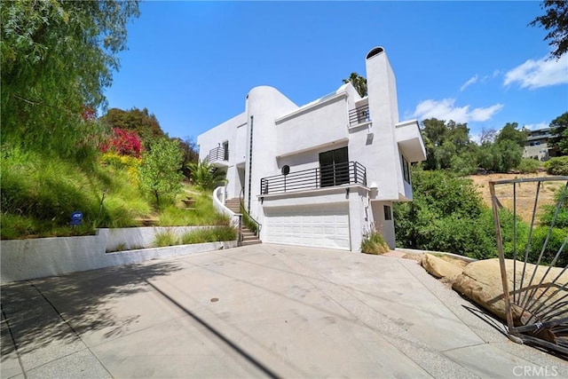 9314 Stevens Way, West Hills, CA 91304 - art deco house with an attached garage, driveway, a balcony, and stucco siding