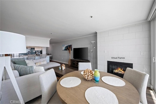 615 Esplanade Unit 509, Redondo Beach, CA 90277 - dining area with a tiled fireplace, ornamental molding, wood finished floors, and baseboards