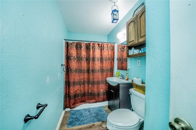 1544 S Pleasant Ave, Ontario, CA 91761 - bathroom with baseboards, a textured wall, toilet, vanity, and a shower with shower curtain