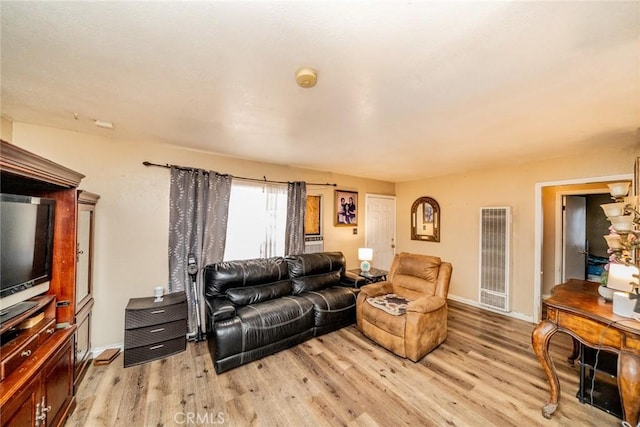 1544 S Pleasant Ave, Ontario, CA 91761 - living room with a heating unit, light wood-style floors, and baseboards