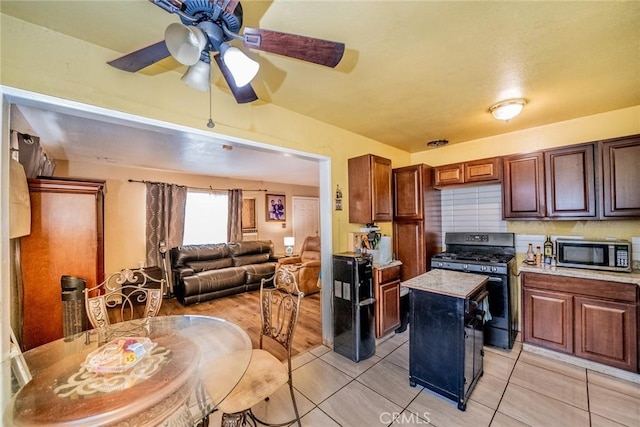 1544 S Pleasant Ave, Ontario, CA 91761 - kitchen featuring stainless steel appliances, a ceiling fan, light countertops, a kitchen island, and open floor plan