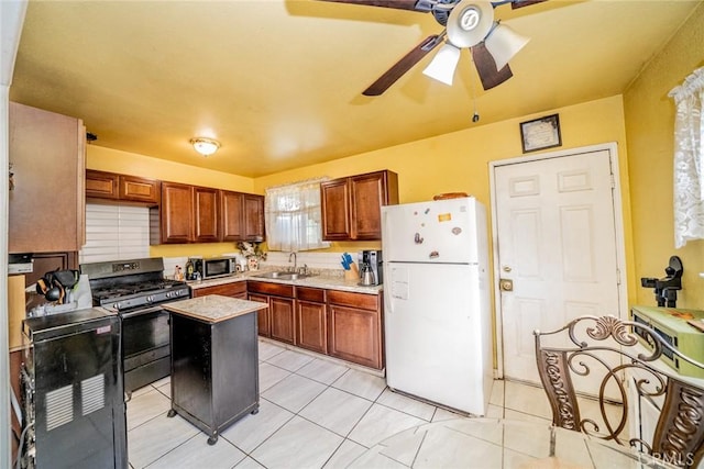 1544 S Pleasant Ave, Ontario, CA 91761 - kitchen featuring appliances with stainless steel finishes, a sink, ceiling fan, light tile patterned floors, and light countertops