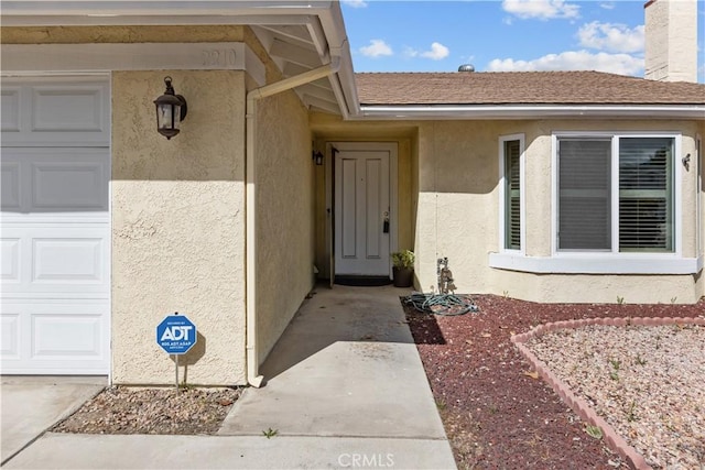 2210 El Rancho Cir, Hemet, CA 92545 - view of exterior entry featuring stucco siding and a chimney