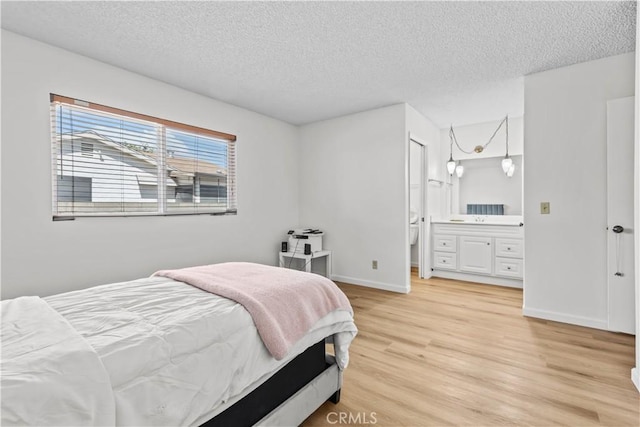 2210 El Rancho Cir, Hemet, CA 92545 - bedroom featuring light wood-style flooring, a textured ceiling, baseboards, and ensuite bath