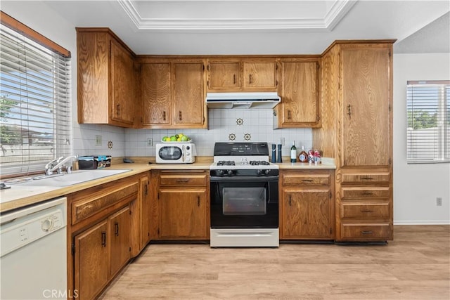 2210 El Rancho Cir, Hemet, CA 92545 - kitchen with range with gas stovetop, dishwasher, under cabinet range hood, a raised ceiling, and decorative backsplash