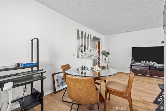 2210 El Rancho Cir, Hemet, CA 92545 - dining area with light wood finished floors, a textured ceiling, and baseboards