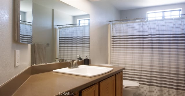 715 Windsong Ln, Nipomo, CA 93444 - bathroom with healthy amount of natural light, toilet, vanity, a textured wall, and a shower with shower curtain