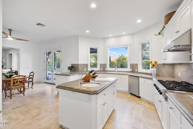 12986 Macdonald Dr, Ojai, CA 93023 - kitchen with appliances with stainless steel finishes, under cabinet range hood, healthy amount of natural light, tasteful backsplash, and recessed lighting