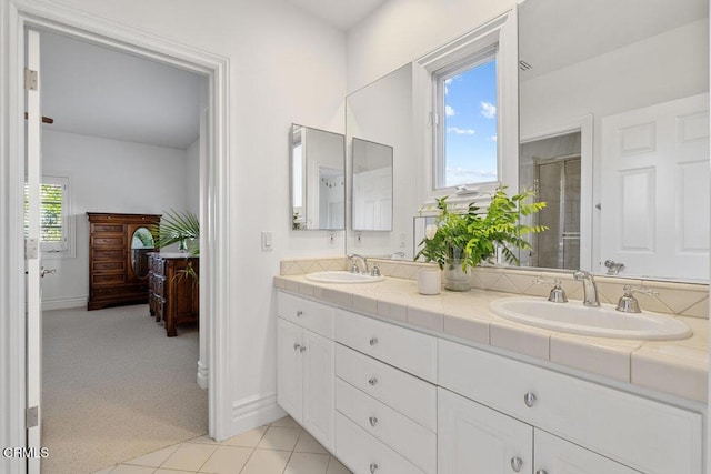 12986 Macdonald Dr, Ojai, CA 93023 - bathroom with double vanity, an enclosed shower, tile patterned flooring, baseboards, and ensuite bathroom