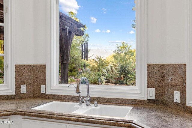 12986 Macdonald Dr, Ojai, CA 93023 - kitchen view of a sink, white cabinetry, and backsplash