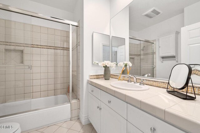 12986 Macdonald Dr, Ojai, CA 93023 - bathroom featuring tile patterned floors, vanity, combined bath / shower with glass door, and toilet