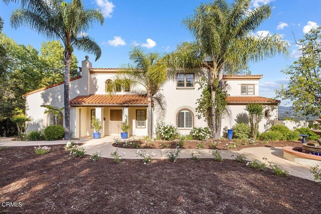 12986 Macdonald Dr, Ojai, CA 93023 - mediterranean / spanish house with stucco siding, a tile roof, a chimney, and a porch